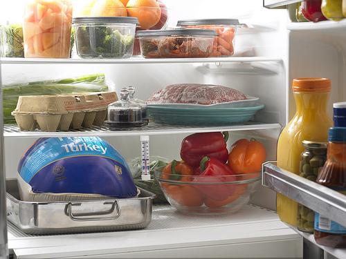 Photo from USDA food blog shows a refrigerator stocked with many items that CalFresh recipients may not be able to buy, such as red peppers, eggs, olives, and assorted condiments.