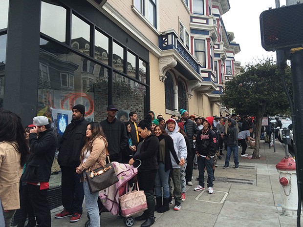 Eager music lovers wait patiently to enter Pink+Dolphin Clothing.
