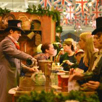 Visitors at the Dickens Fair enjoy refreshments served by workers dressed in full Victorian London costumes.