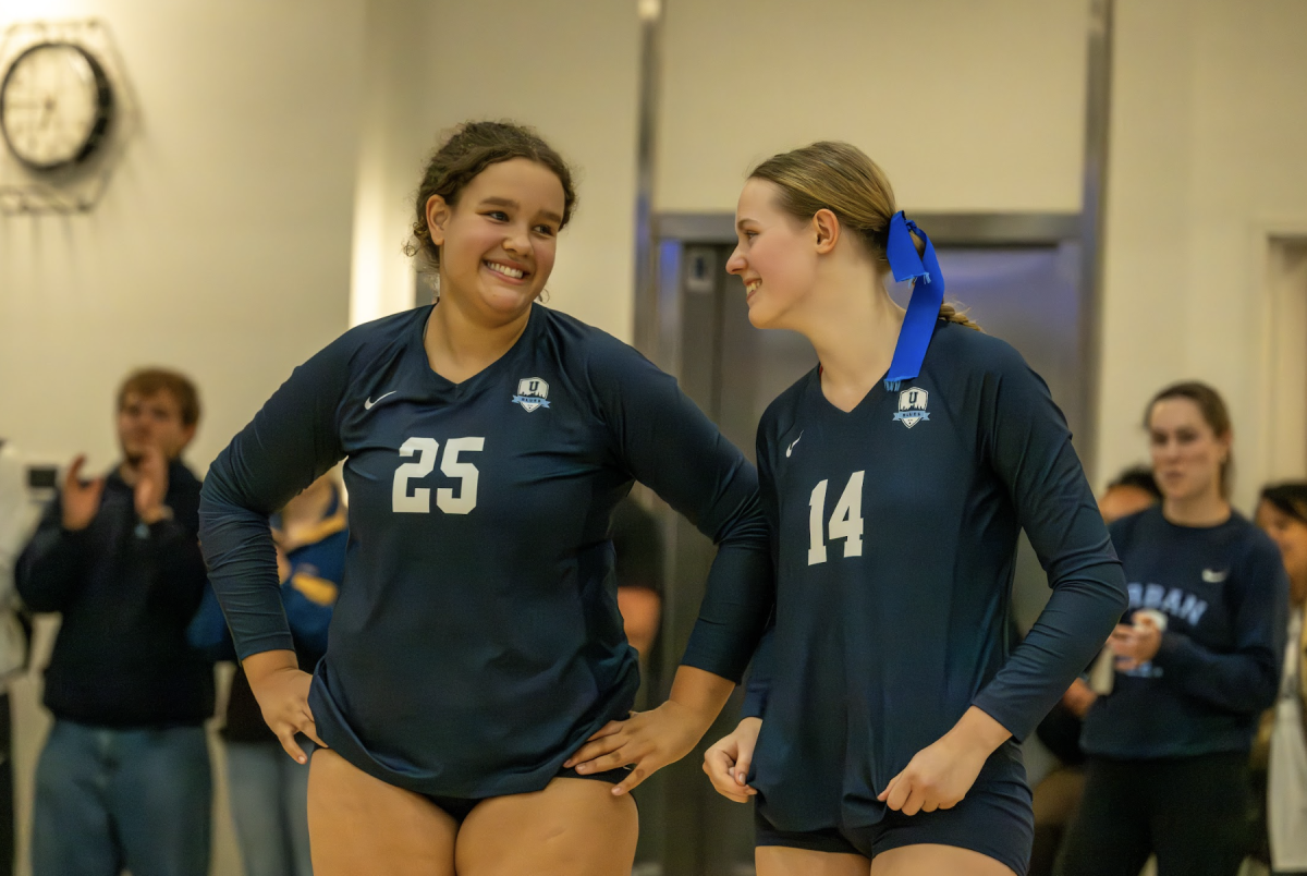 Team captains Kyle Speta ’26 and Lucy Bone ’26 at a volleyball match on Oct. 15. Photo credit: Ajay Haddad. 